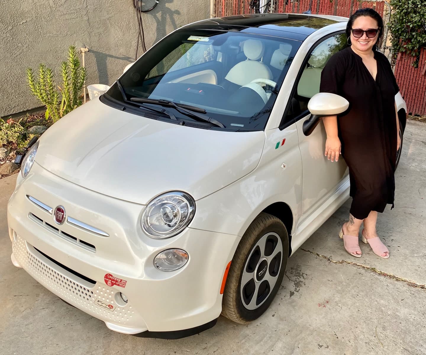Woman standing next to her electric car